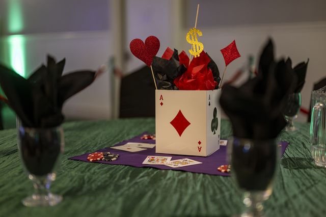 Book release party: Centerpiece with playing-card suits and black napkins