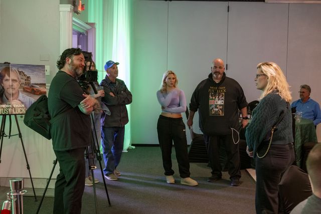 Book release party: A camera operator films guests talking