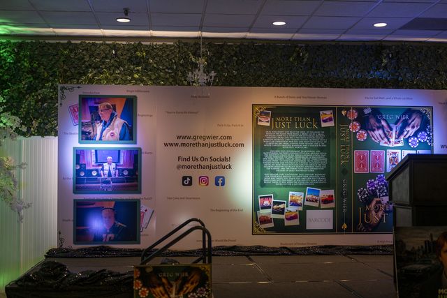 Book release party: Stage and book display wall lit in blue and green