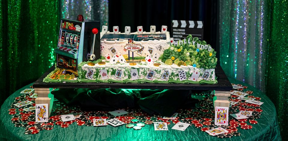 Casino-themed release party cake on a table of poker chips and cards