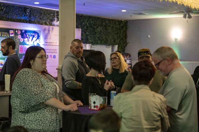 Book release party: Guests gathered and talking between tables
