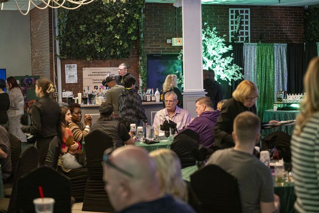 Book release party: Guests seated at tables around the hall