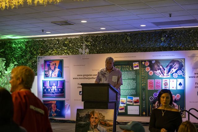 Book release party: A speaker at the podium in front of the display wall