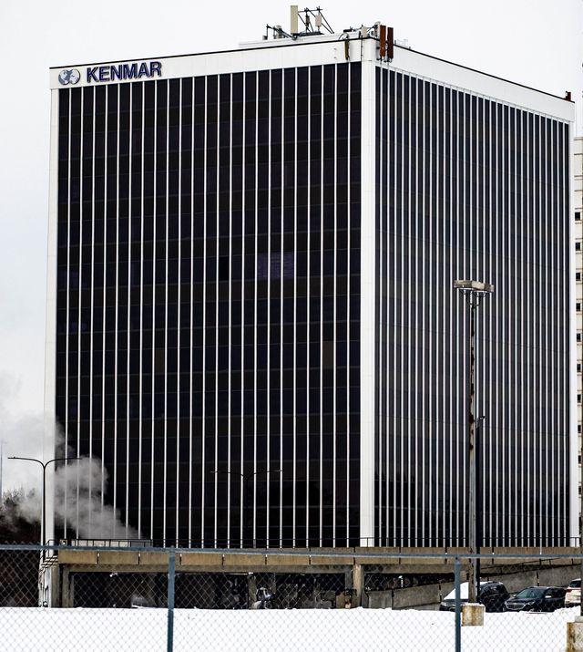 Black glass office tower with a Kenmar sign