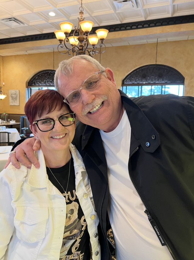 A couple posing together in a restaurant
