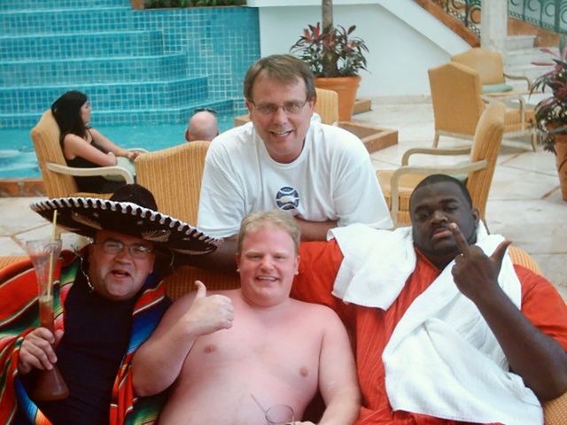 Friends at a hotel pool, one in a sombrero