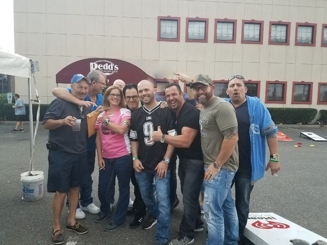 Friends tailgating outside a stadium