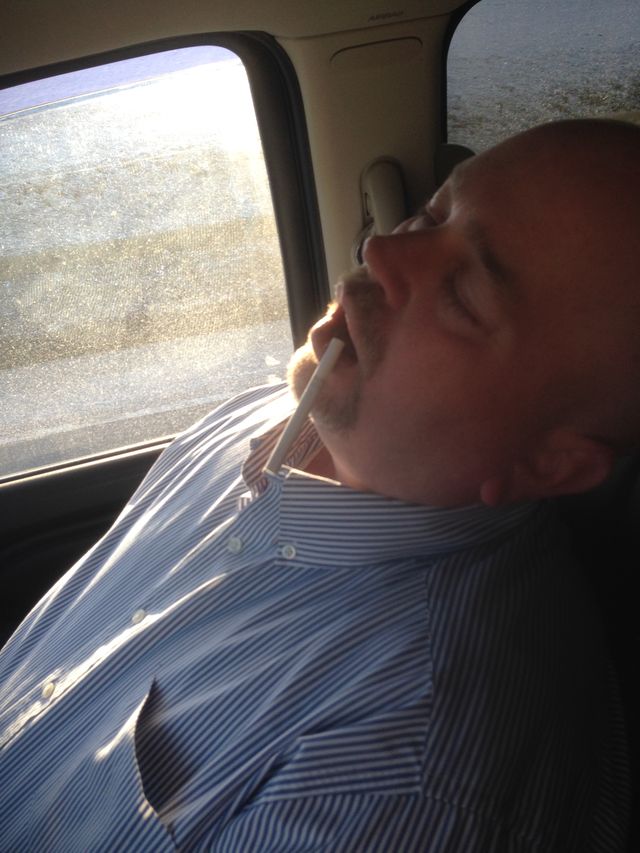 A man asleep in a car seat