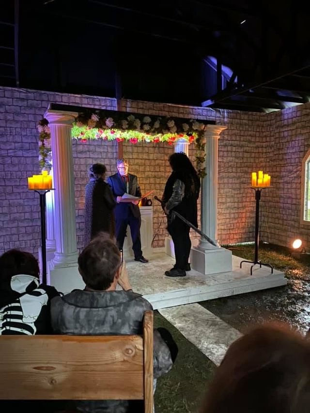 Performers on a lit stage set