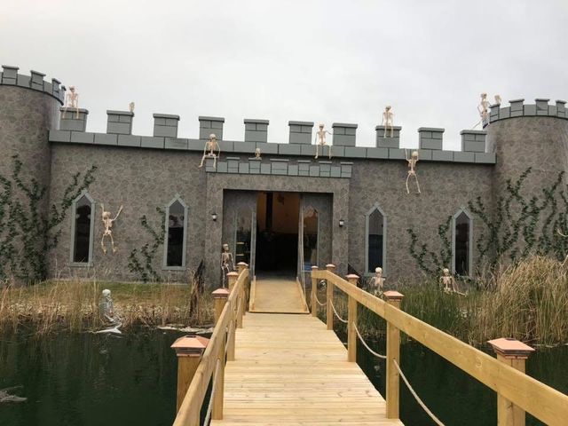 Castle-style building with a wooden footbridge, decorated for Halloween