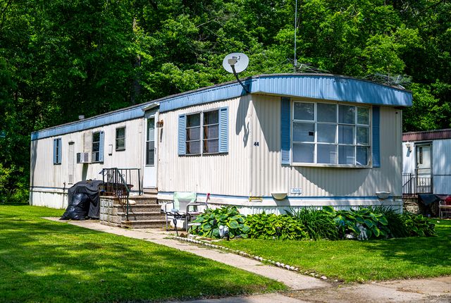 Mobile home with blue trim in summer