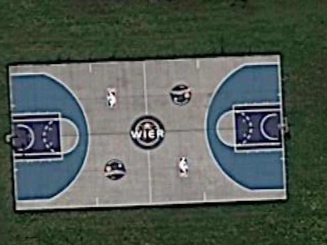Aerial view of a basketball court with the Wier logo at center court