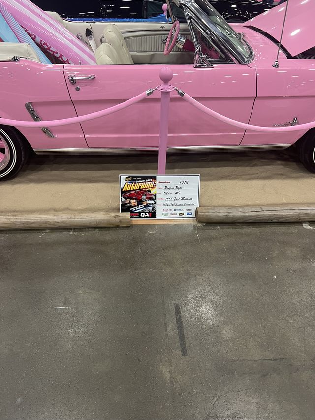 Pink Mustang display at a car show