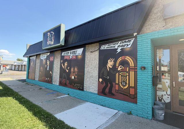 Teal building with music-themed murals