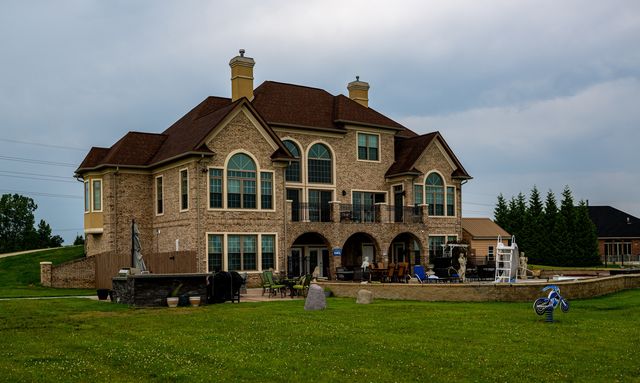 Large stone house with balconies in summer