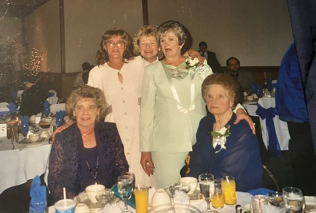 Women posing at a banquet table