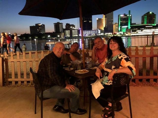 Friends at dinner on a patio at dusk