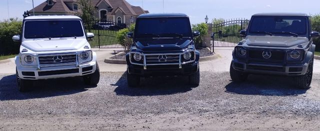 Three Mercedes-Benz G-Class SUVs parked side by side