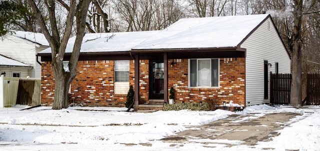 Brick ranch house in the snow