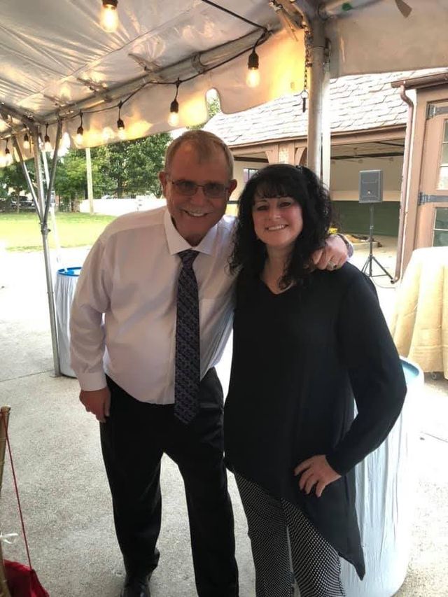 A man and woman posing under a tent