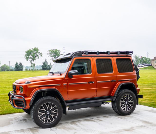 Orange Mercedes-Benz G-Class with a roof rack