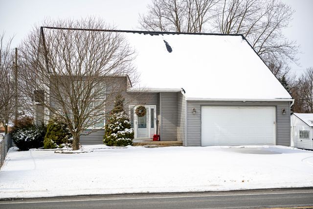Two-story house with a garage in the snow