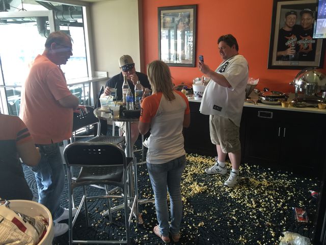 People in a bar with popcorn on the floor