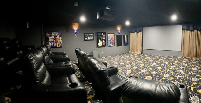 Home theater with rows of leather recliners