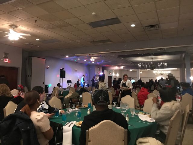 Banquet hall full of guests at round tables